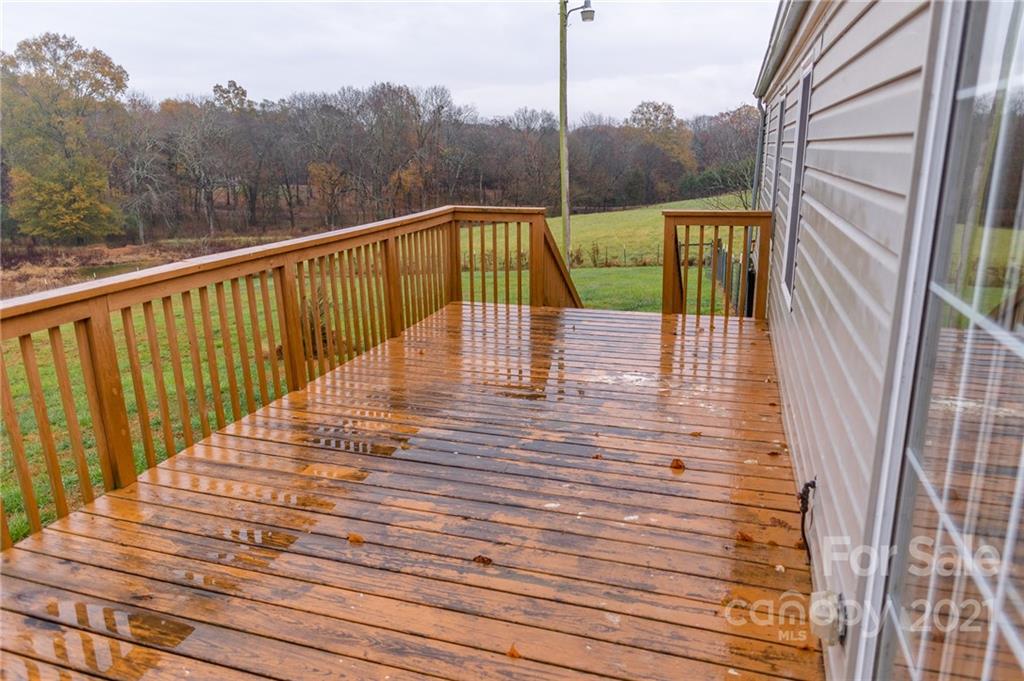 5432 Rushing Road Stanfield, NC 28163 - Photo 28 of 34 a view of balcony with wooden floor and fence