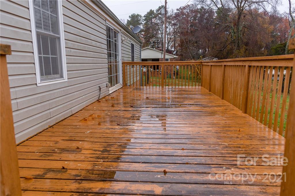 5432 Rushing Road Stanfield, NC 28163 - Photo 30 of 34 a view of balcony with wooden floor and fence