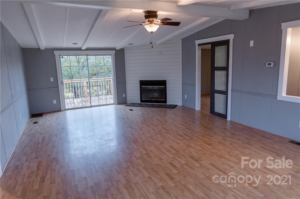 5432 Rushing Road Stanfield, NC 28163 - Photo 6 of 34 wooden floor fireplace and windows in an empty room