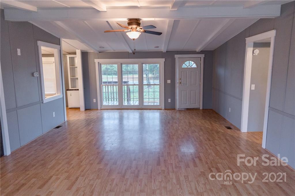5432 Rushing Road Stanfield, NC 28163 - Photo 7 of 34 a view of empty room with wooden floor and fan
