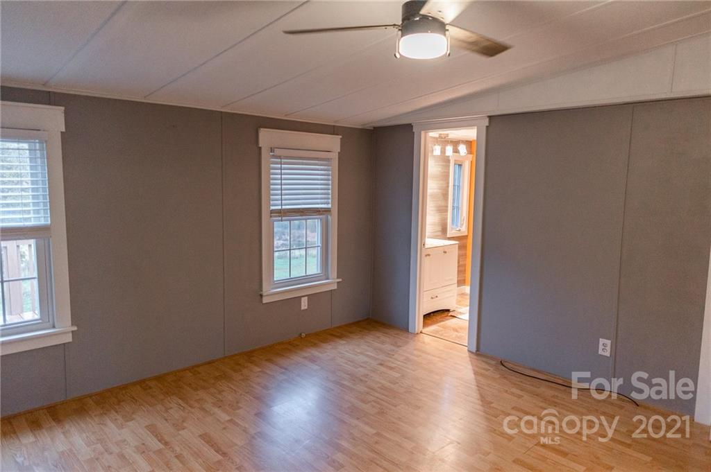 5432 Rushing Road Stanfield, NC 28163 - Photo 8 of 34 a view of an empty room with a window and wooden floor