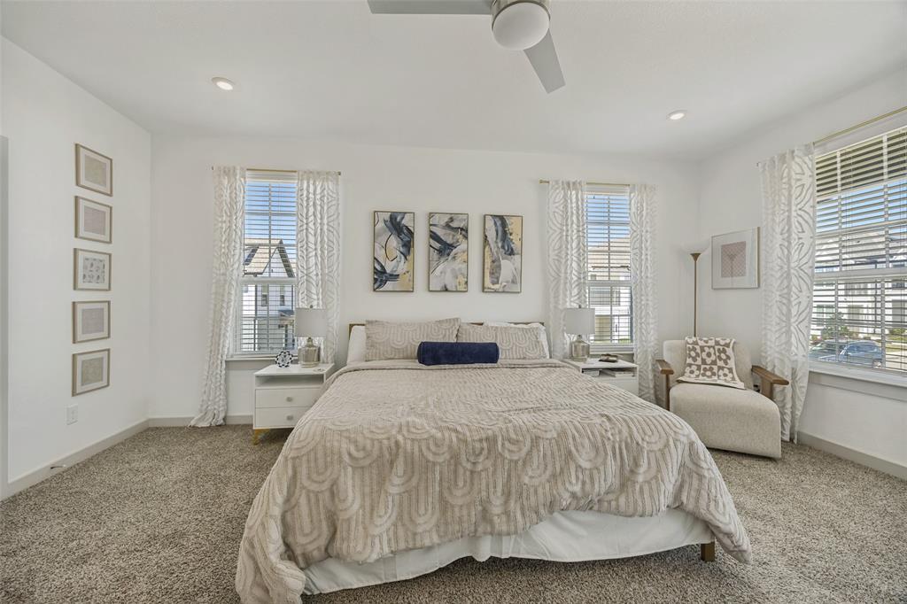 1650 Jessica Lane Allen, TX 75002 - Photo 19 of 25 a spacious bedroom with a bed a couch and large window