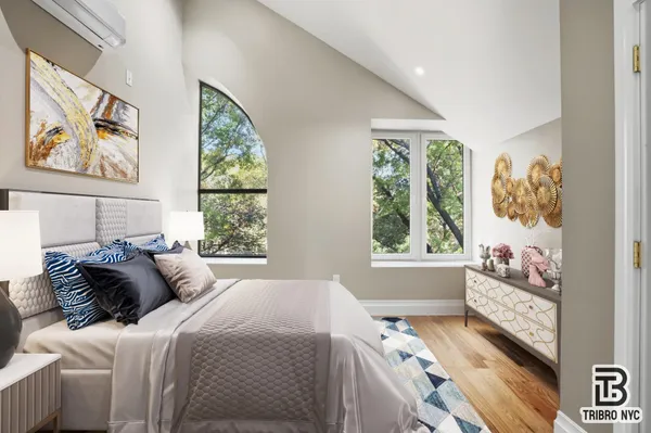a bedroom with a bed and a window with outer view