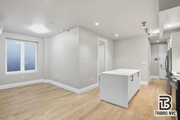 a view of a bathroom with sink mirror and window