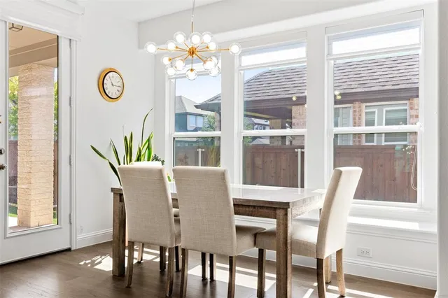 a view of a dining room with furniture wooden floor and chandelier