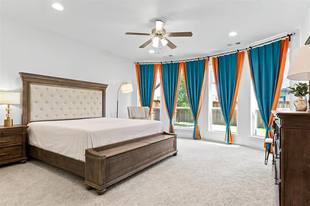 a spacious bedroom with a large bed and a large window