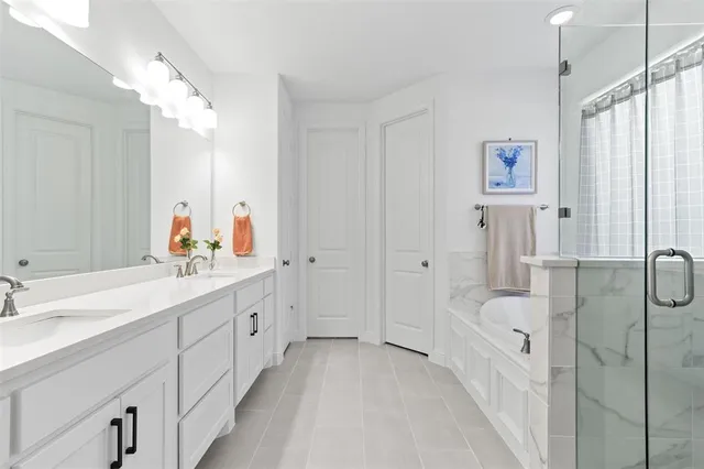 a bathroom with a tub sink and mirror