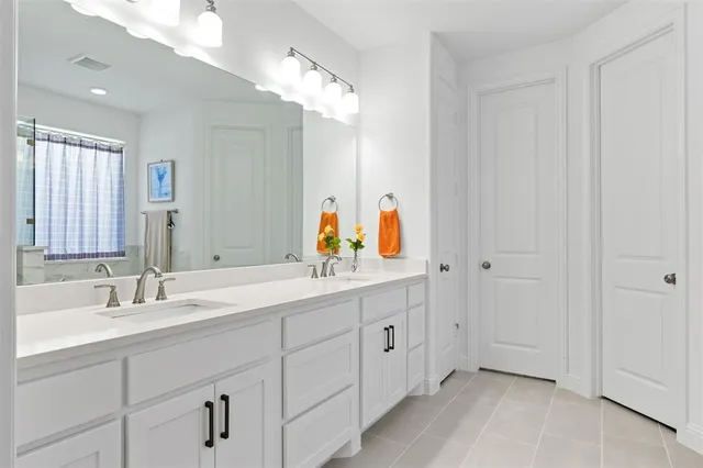 a spacious bathroom with a double vanity sink mirror and