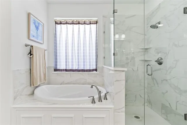 a bathroom with a bathtub and shower
