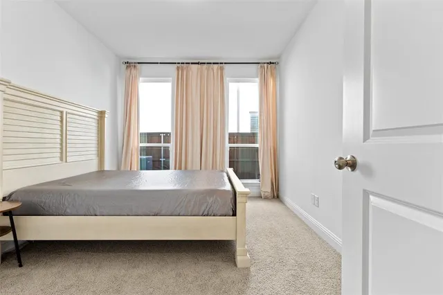 a large bed sitting in a room next to a window