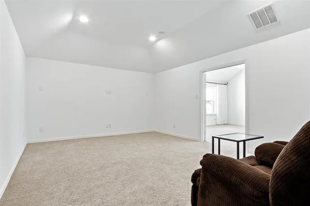 a view of a livingroom with furniture and a window