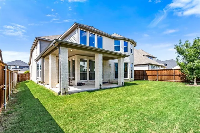 a view of a house with a yard and plants