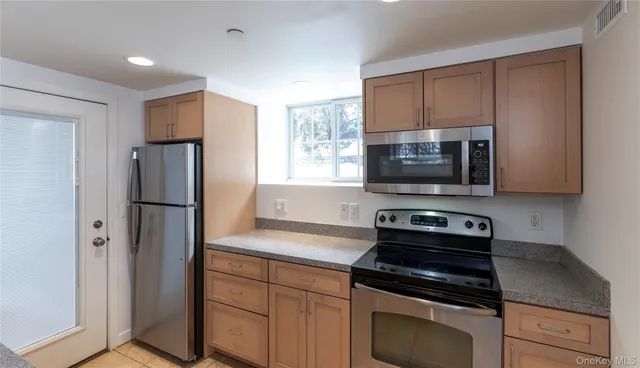 a kitchen with a refrigerator stove and microwave