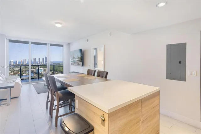a open kitchen with dining table and chairs