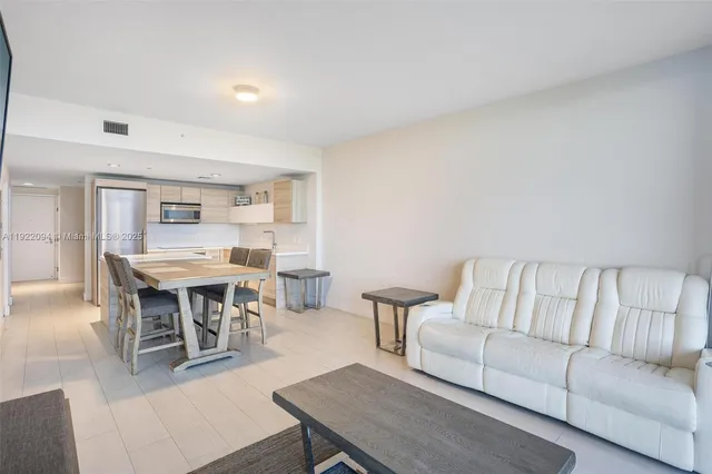 a living room with furniture a dining table and a piano table