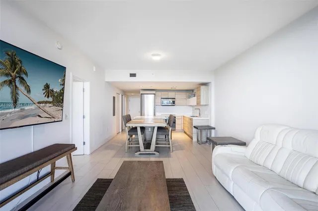 a living room with furniture a rug and a table