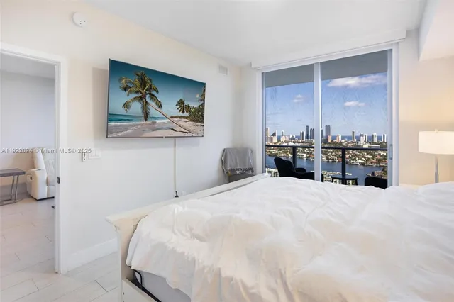 a bedroom with a bed and a large mirror