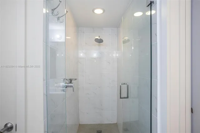 a bathroom with a shower and a mirror