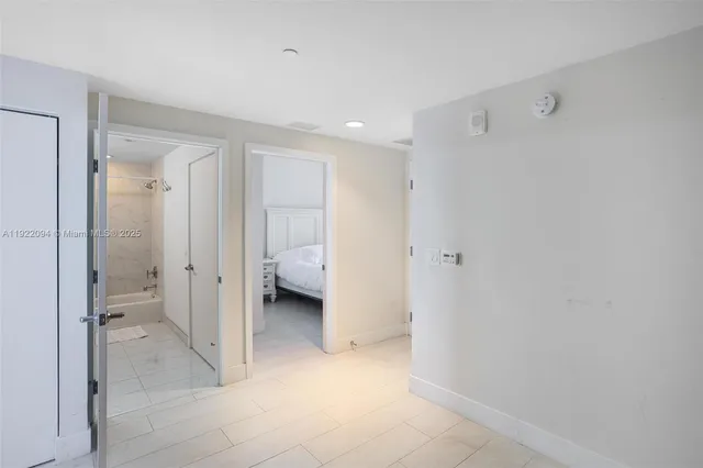 a spacious bathroom with a glass shower door and a sink