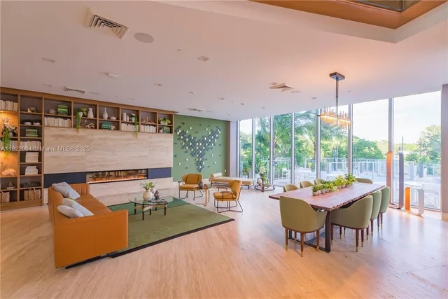 a living room with furniture and a floor to ceiling window