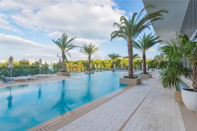a view of swimming pool with a table and chairs