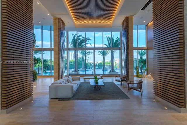 a living room with furniture and large windows