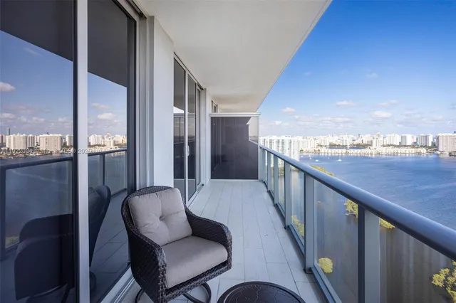 a balcony with table and chairs