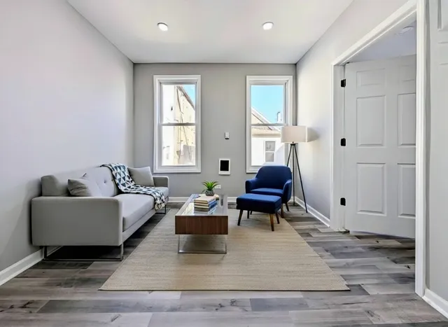 a living room with furniture rug and window