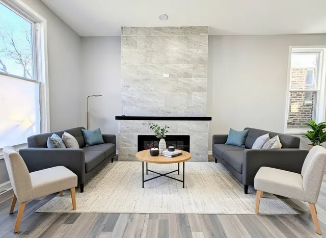 a living room with furniture and a fireplace