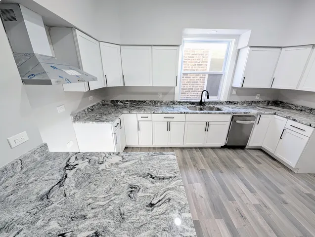 a kitchen with granite countertop a stove a sink and a granite counter tops