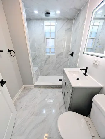 a bathroom with a sink mirror bathtub and toilet