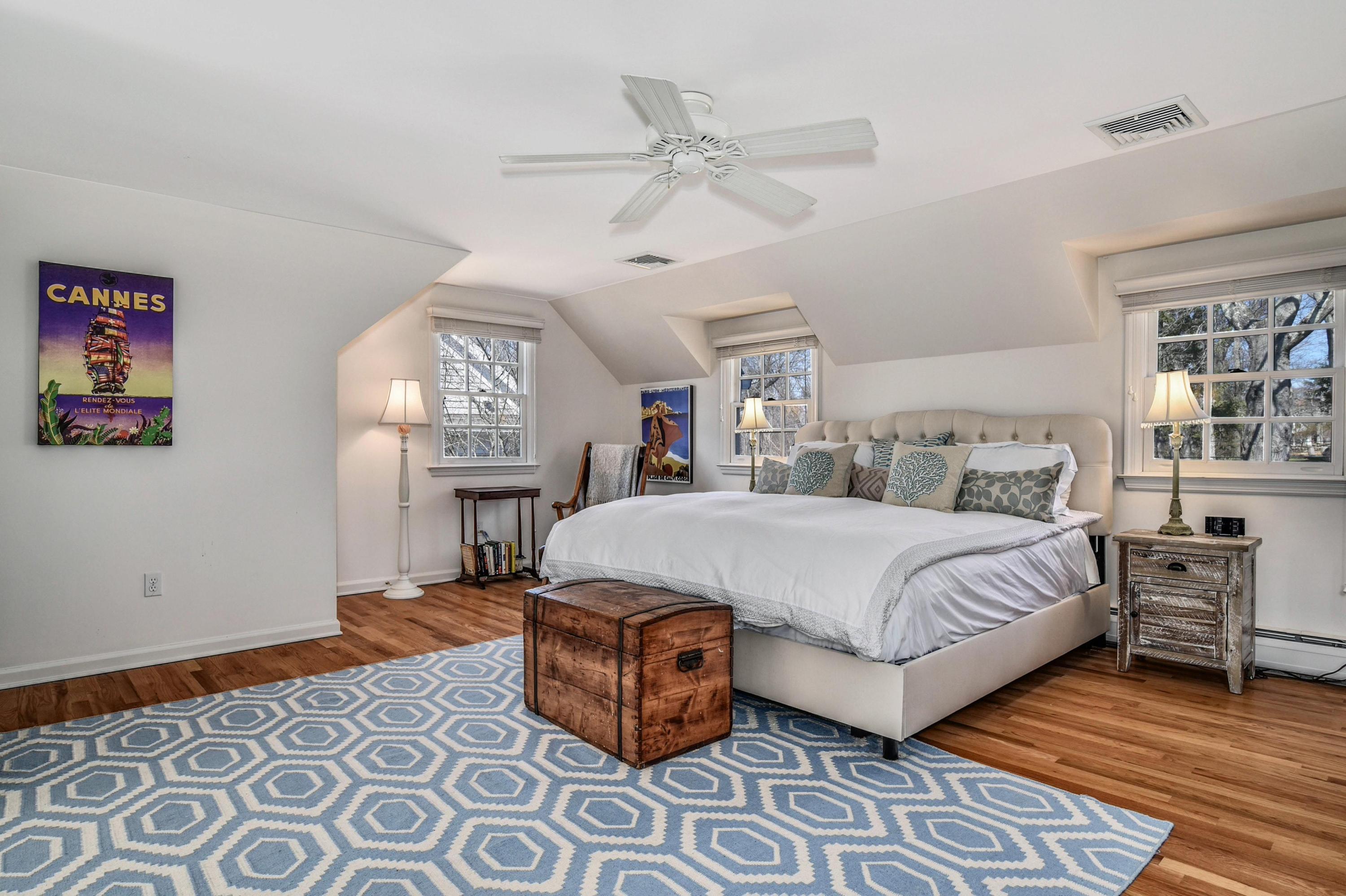 28 Briar Brae Road Darien, CT 06820 - Photo 14 of 33 a bedroom with a large bed and a chandelier
