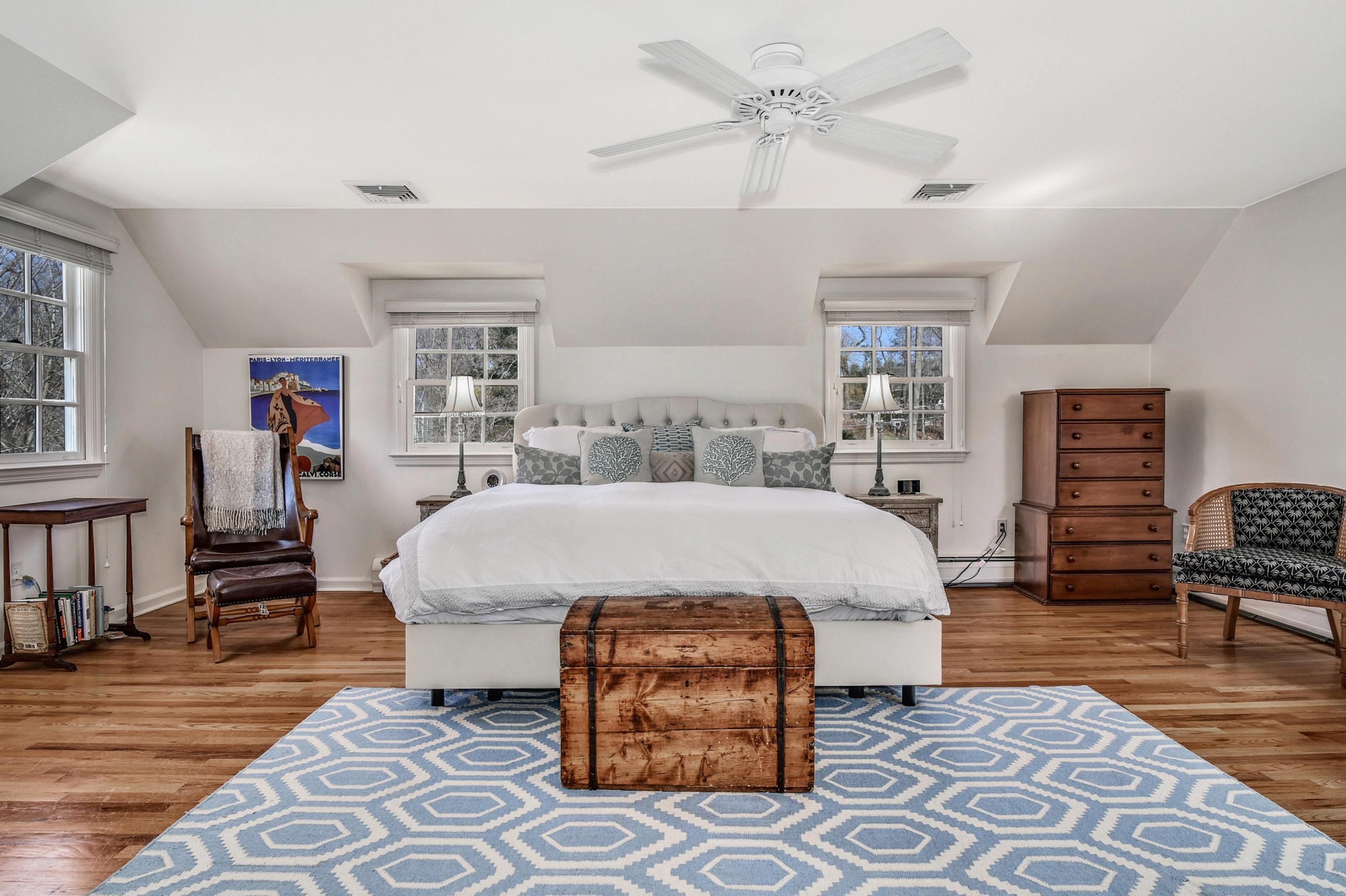 28 Briar Brae Road Darien, CT 06820 - Photo 15 of 33 a bed sitting in a spacious bedroom next to a window with a dresser