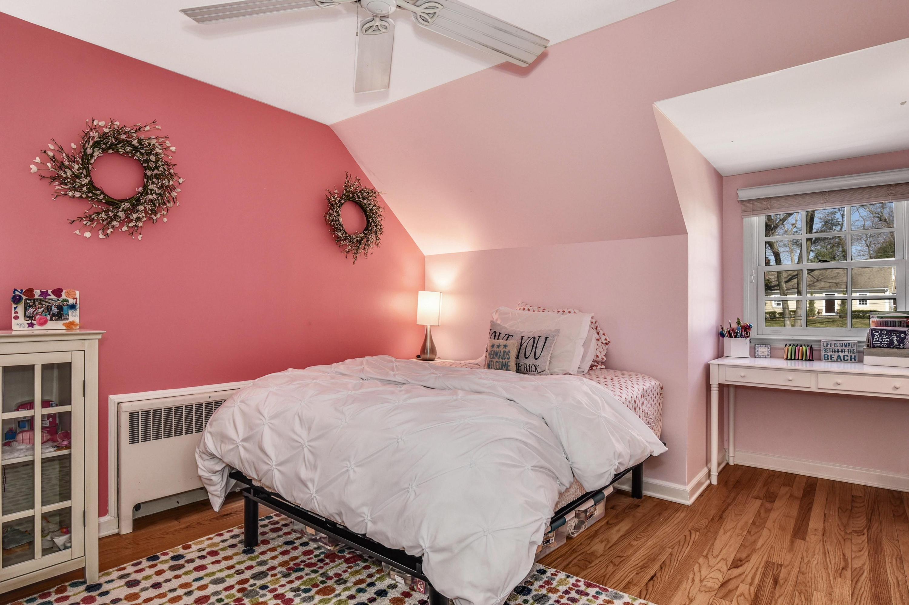 28 Briar Brae Road Darien, CT 06820 - Photo 21 of 33 a bedroom with a bed and a chandelier