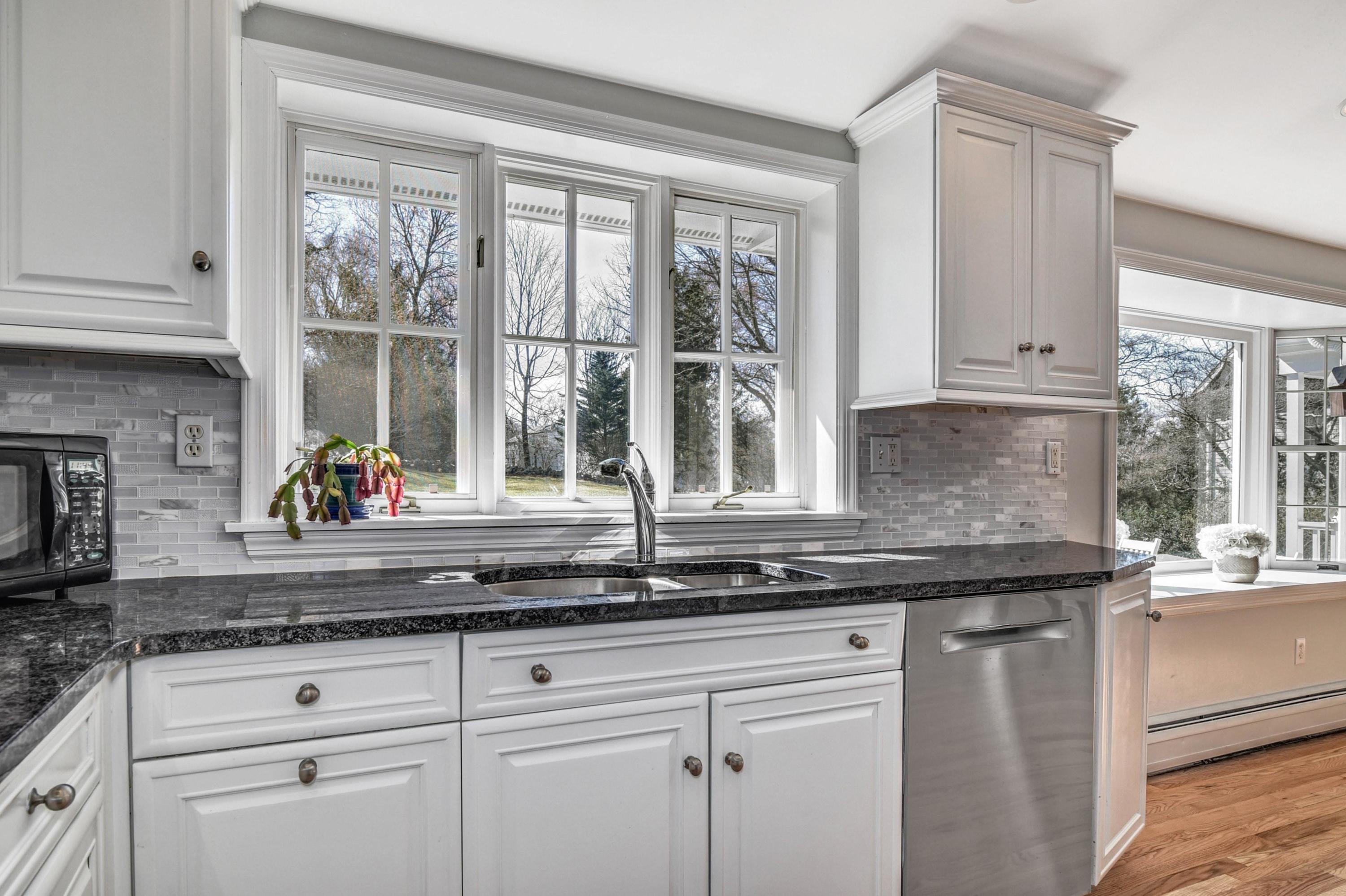 28 Briar Brae Road Darien, CT 06820 - Photo 3 of 33 a kitchen with granite countertop white cabinets and a window