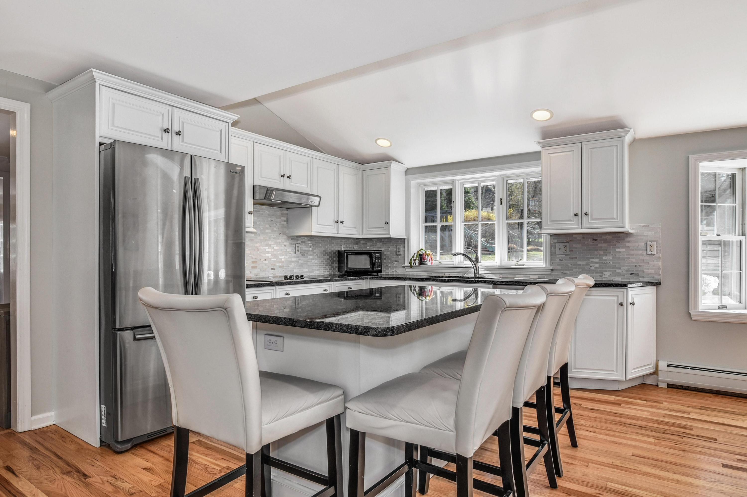 28 Briar Brae Road Darien, CT 06820 - Photo 4 of 33 a kitchen with a table chairs refrigerator and cabinets