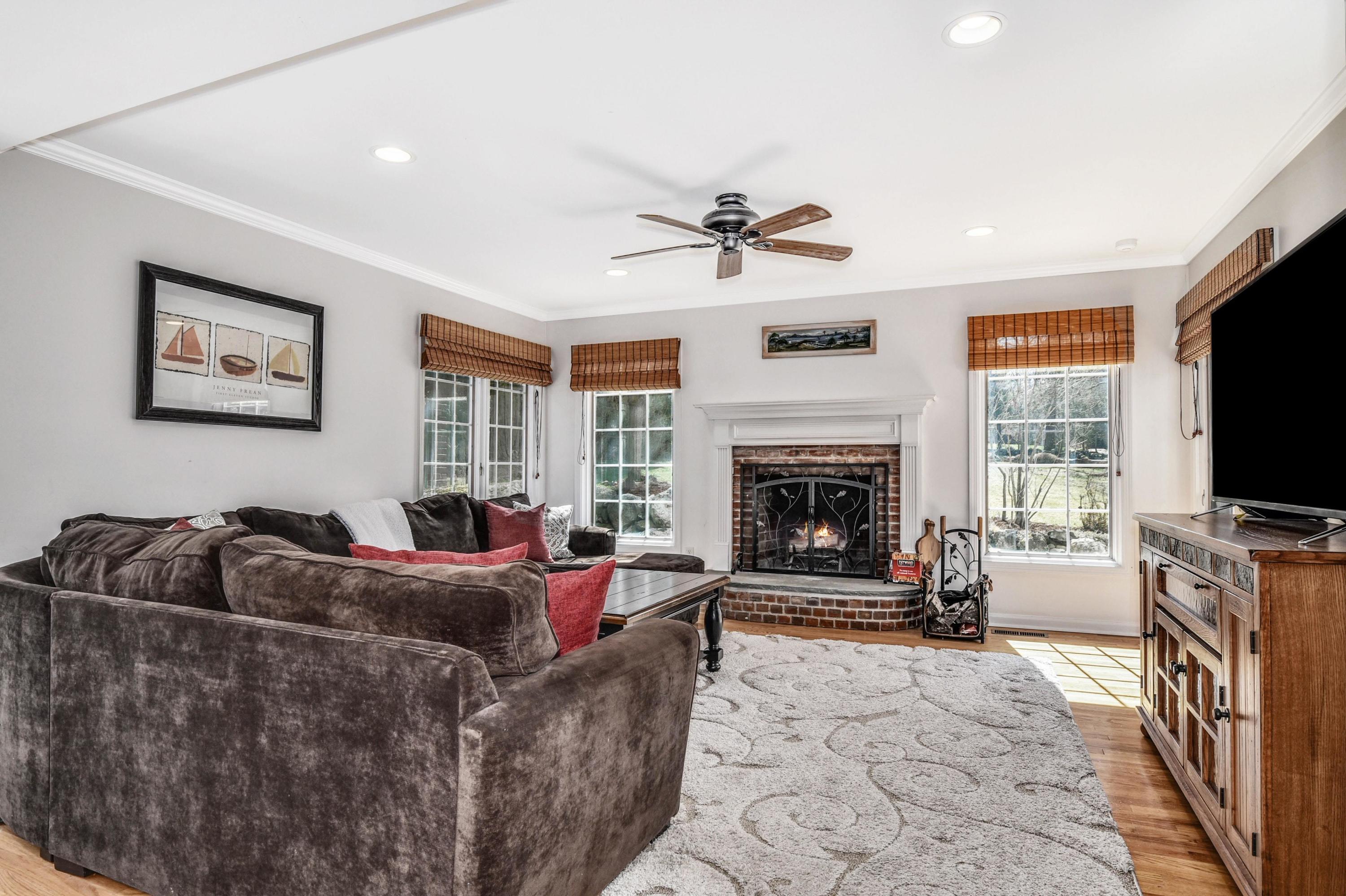 28 Briar Brae Road Darien, CT 06820 - Photo 7 of 33 a living room with furniture a flat screen tv and a fireplace