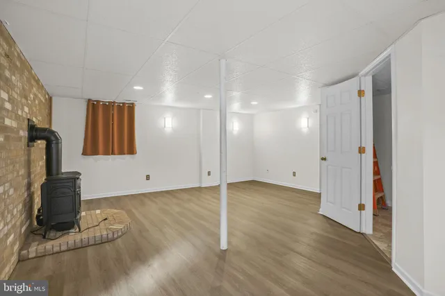 a view of a room with wooden floor and a cabinet