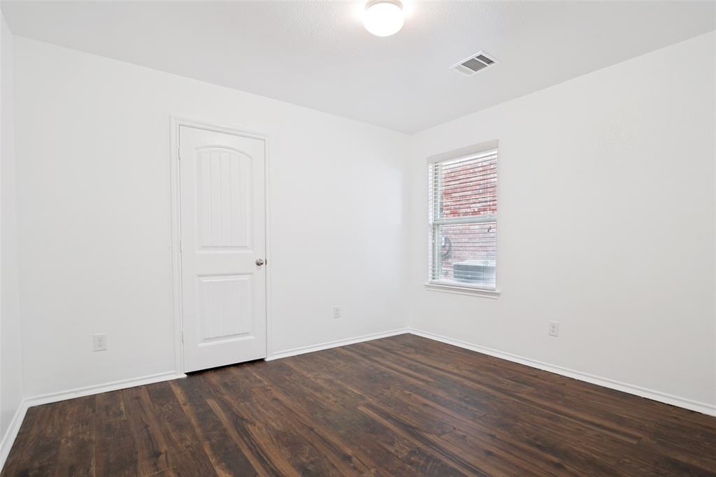 3415 Emerson Road Forney, TX 75126 - Photo 15 of 26 a view of an empty room with wooden floor and a window