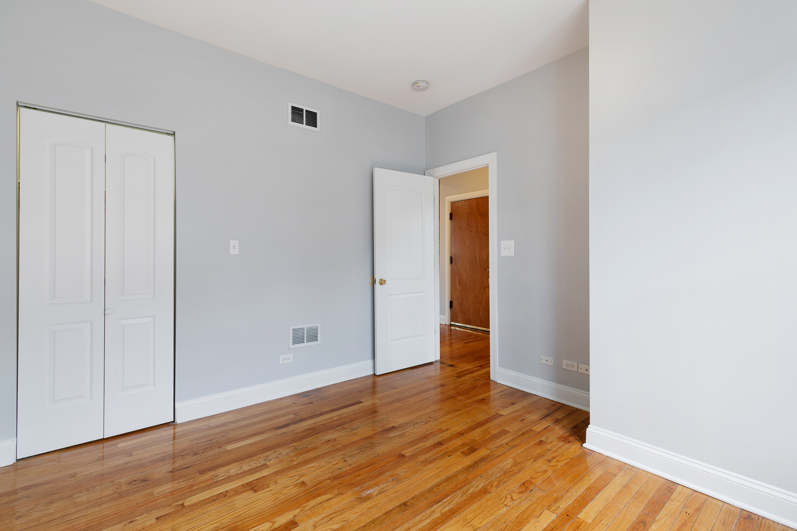 2011 West Jarvis Avenue, Unit 3 Chicago, IL 60645 - Photo 10 of 16 a view of an empty room with wooden floor