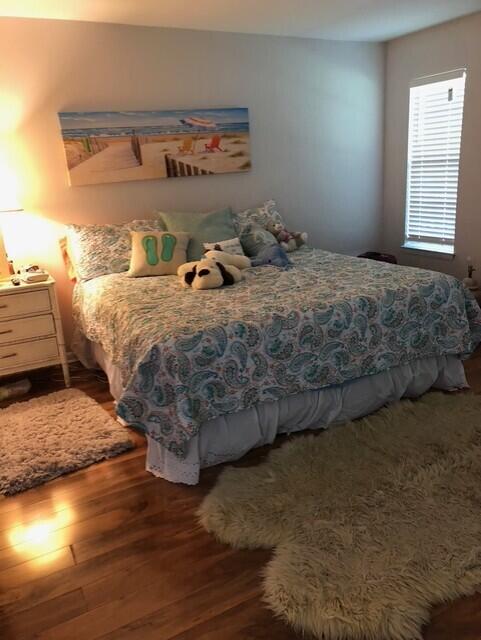 402 Juniper Street Destin, FL 32541 - Photo 12 of 20 a bedroom with a bed and wooden floor