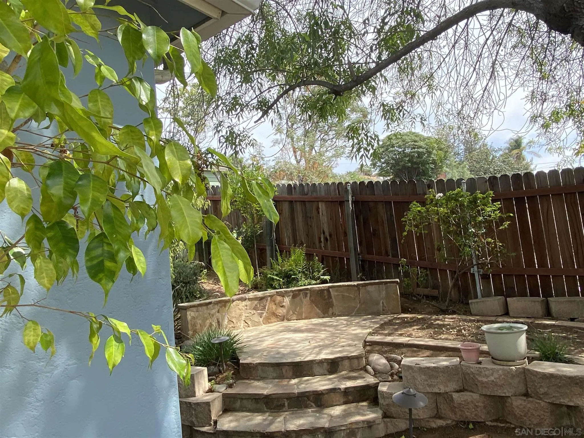 9243 Westhill Road Lakeside, CA 92040 - Photo 9 of 26 a view of a backyard with plants and wooden fence