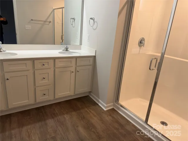 a bathroom with a glass shower door