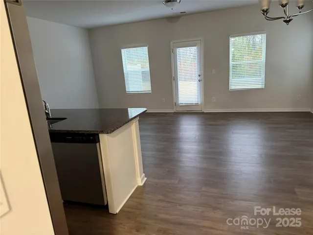 a kitchen with stainless steel appliances granite countertop a refrigerator a stove a sink and a microwave