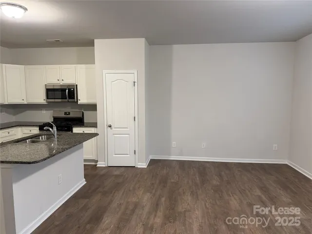 a kitchen with a refrigerator a stove top oven a sink and dishwasher