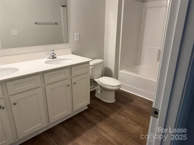 a bathroom with a sink toilet a mirror and shower