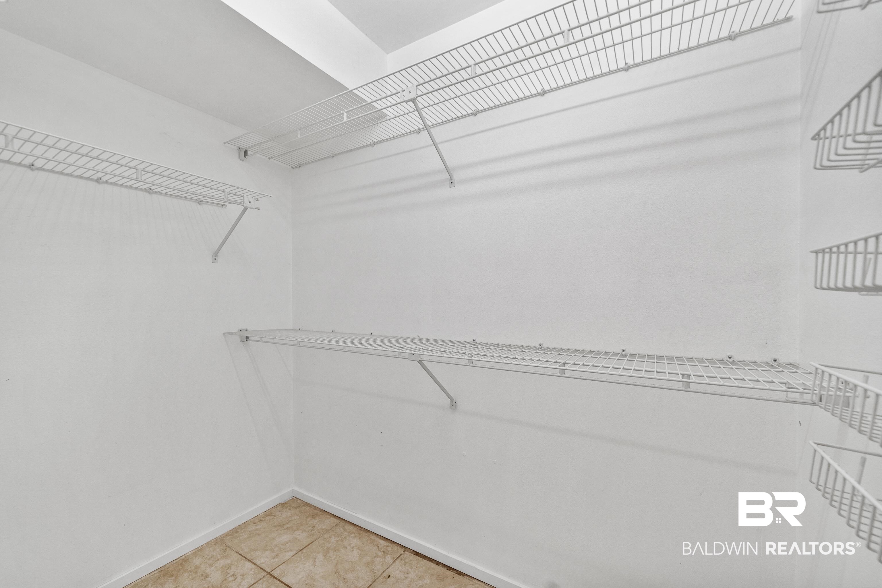 1701 Regency Road, Unit 111 Gulf Shores, AL 36542 - Photo 18 of 29 Walk in closet with light tile patterned flooring