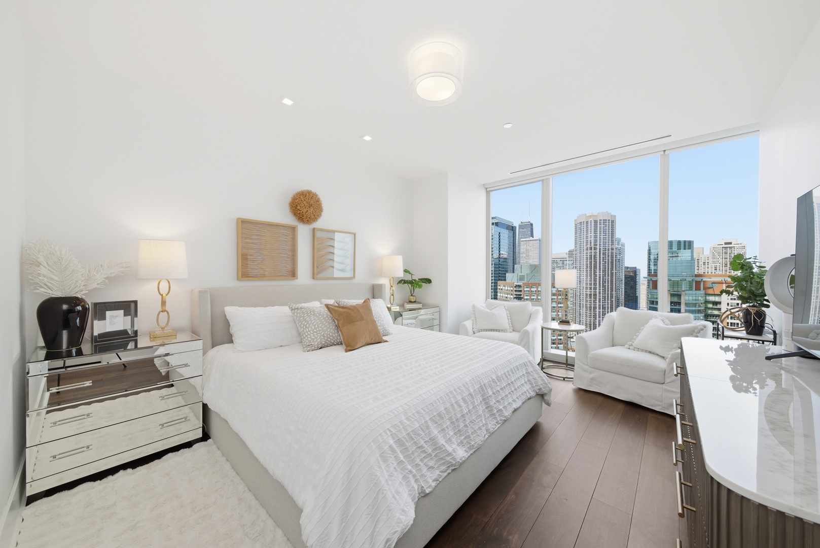 363 East Wacker Drive, Unit 2708 Chicago, IL 60601 - Photo 13 of 48 a bedroom with a large bed and a couch