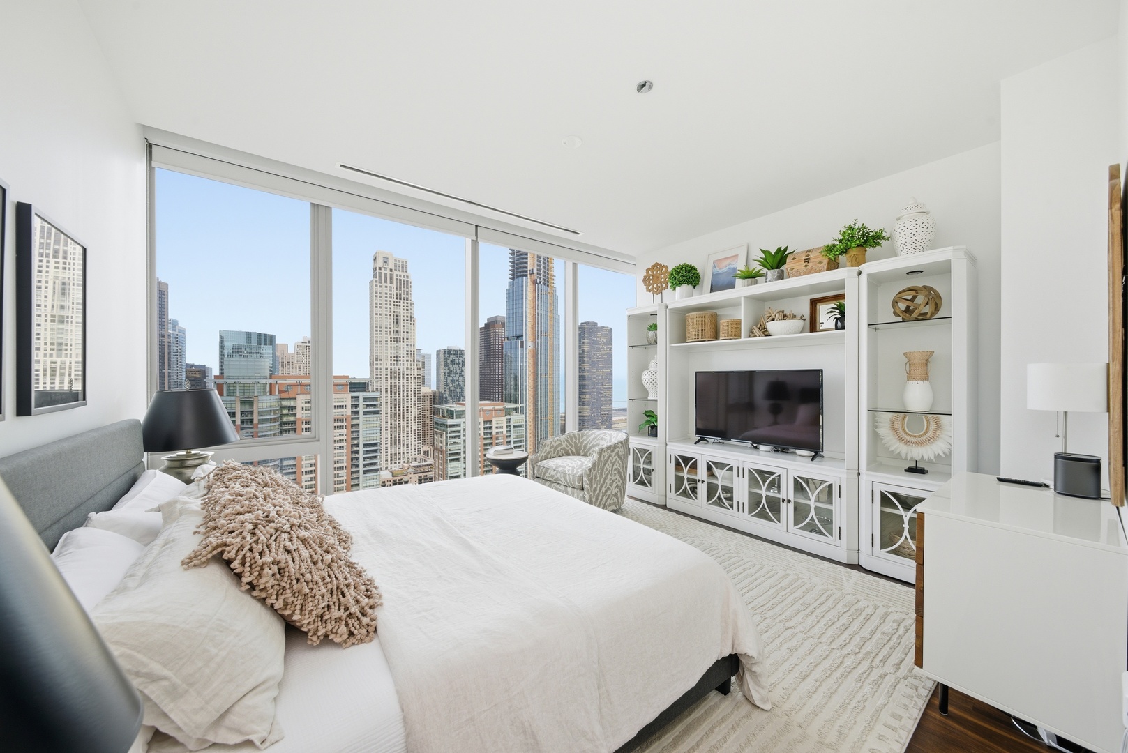 363 East Wacker Drive, Unit 2708 Chicago, IL 60601 - Photo 17 of 48 a bedroom with furniture and a flat screen tv
