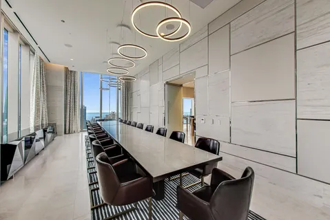 a living room with furniture and a floor to ceiling window
